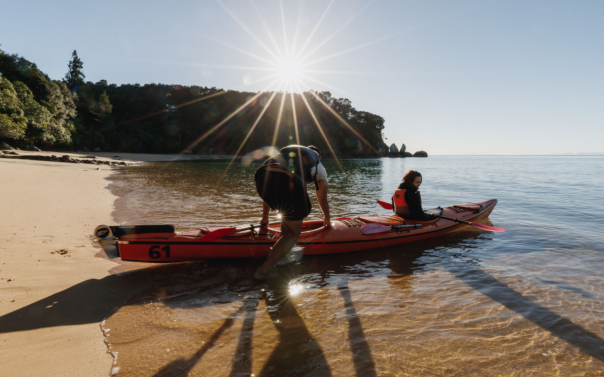 Zero carbon couple kayaking MSK Abel Tasman beach sunset