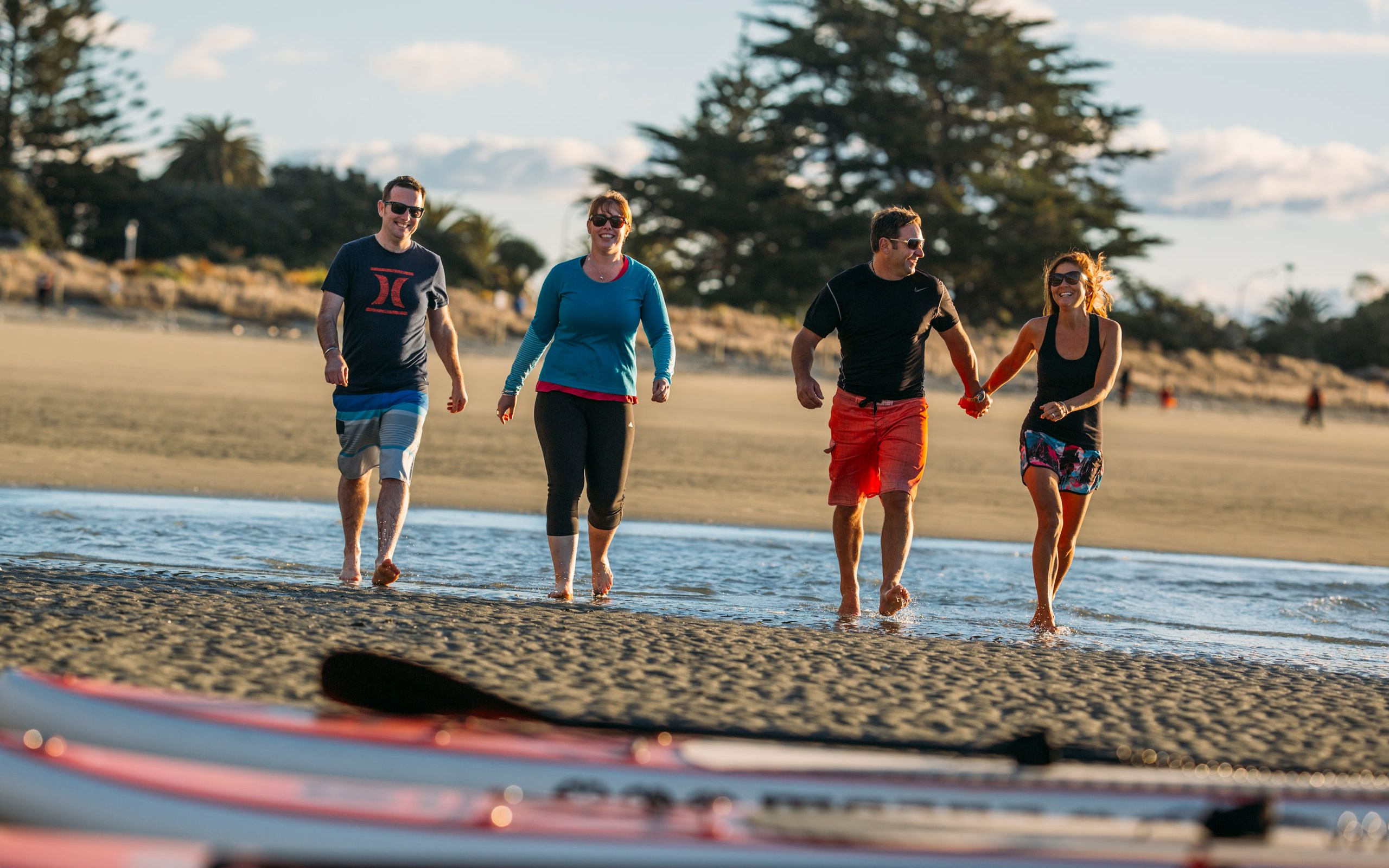 Strolling Tahunanui Beach Toward Paddleboards